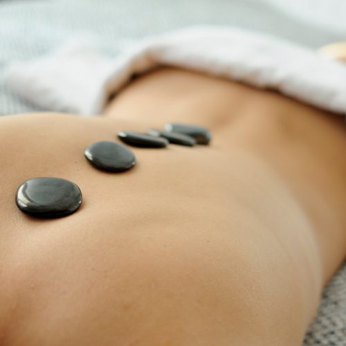 close-up-woman-s-back-with-hot-stones-treatment_1139-445
